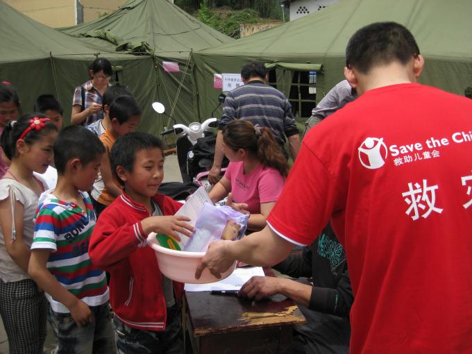 Children line up to receive relief supplies from Save the Children in the aftermath of the Ya’an earthquake that struck Sichuan province in April 2013.