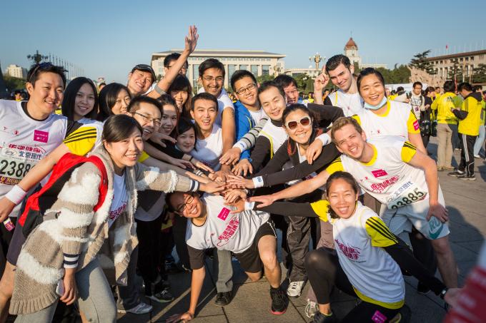 Save the Children’s Beijing Marathon team join their hands together for child survival.